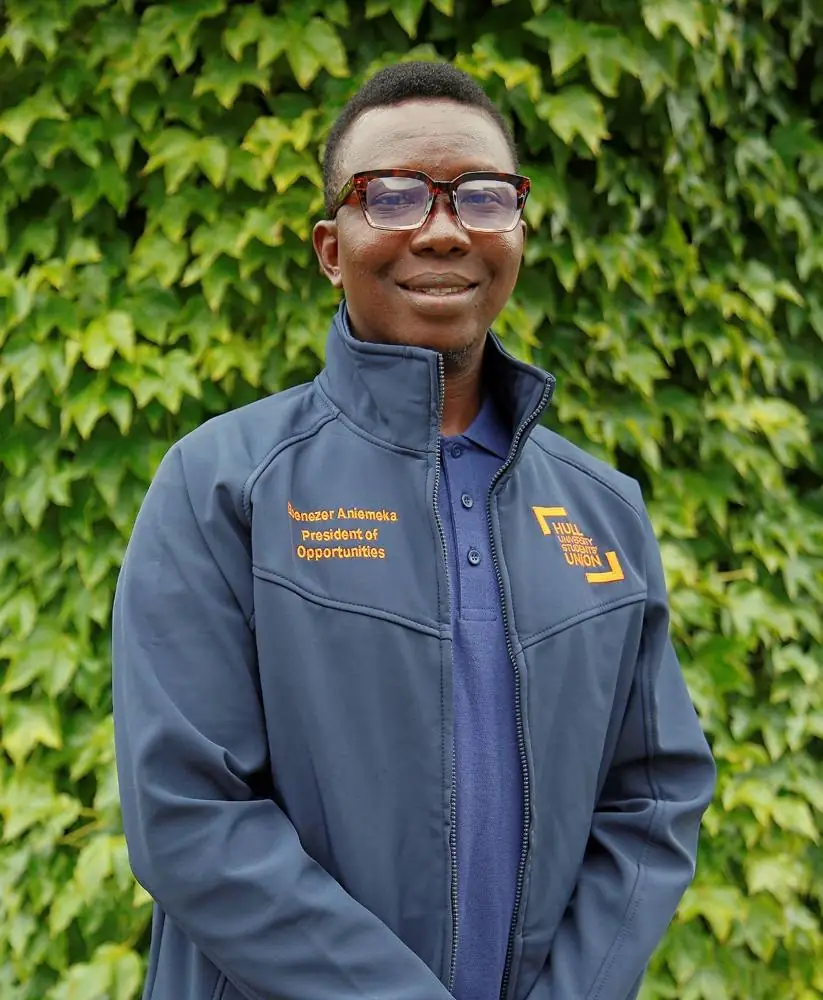 Ebenezer Aniemeka smiling in a navy Hull University Students’ Union jacket