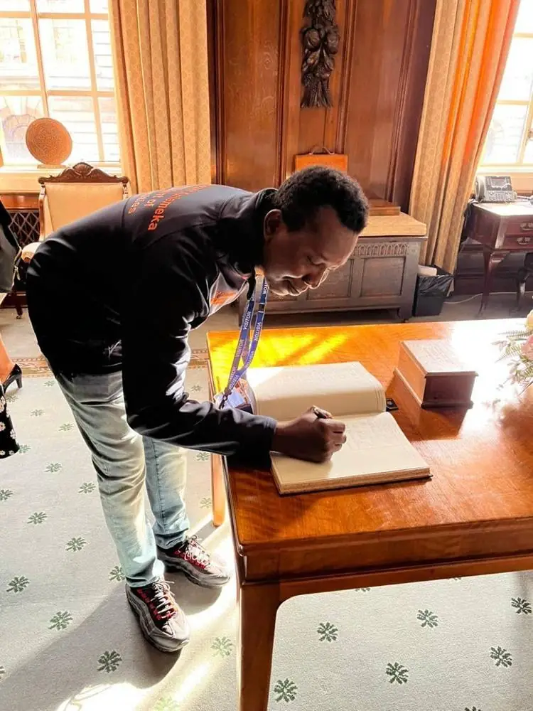 Ebenezer signing the visitors’ book at the Guildhall
